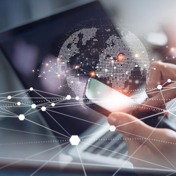 Woman using mobile phone and laptop computer surfing internet.